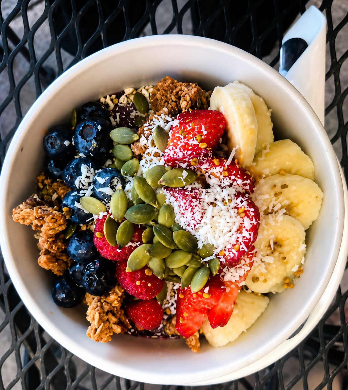 Yogurt bowl with fruit, granola, and seeds